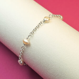 foto com pulseira infantil com pérolas e corrente de prata